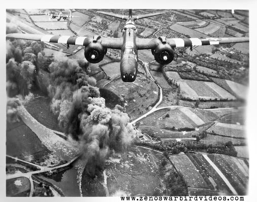 Photo of an Douglas A-20 Havoc attack bombers wearing "invasion stripes" bombing a bridge in Nothern France during the D-Day landings in World War 2.